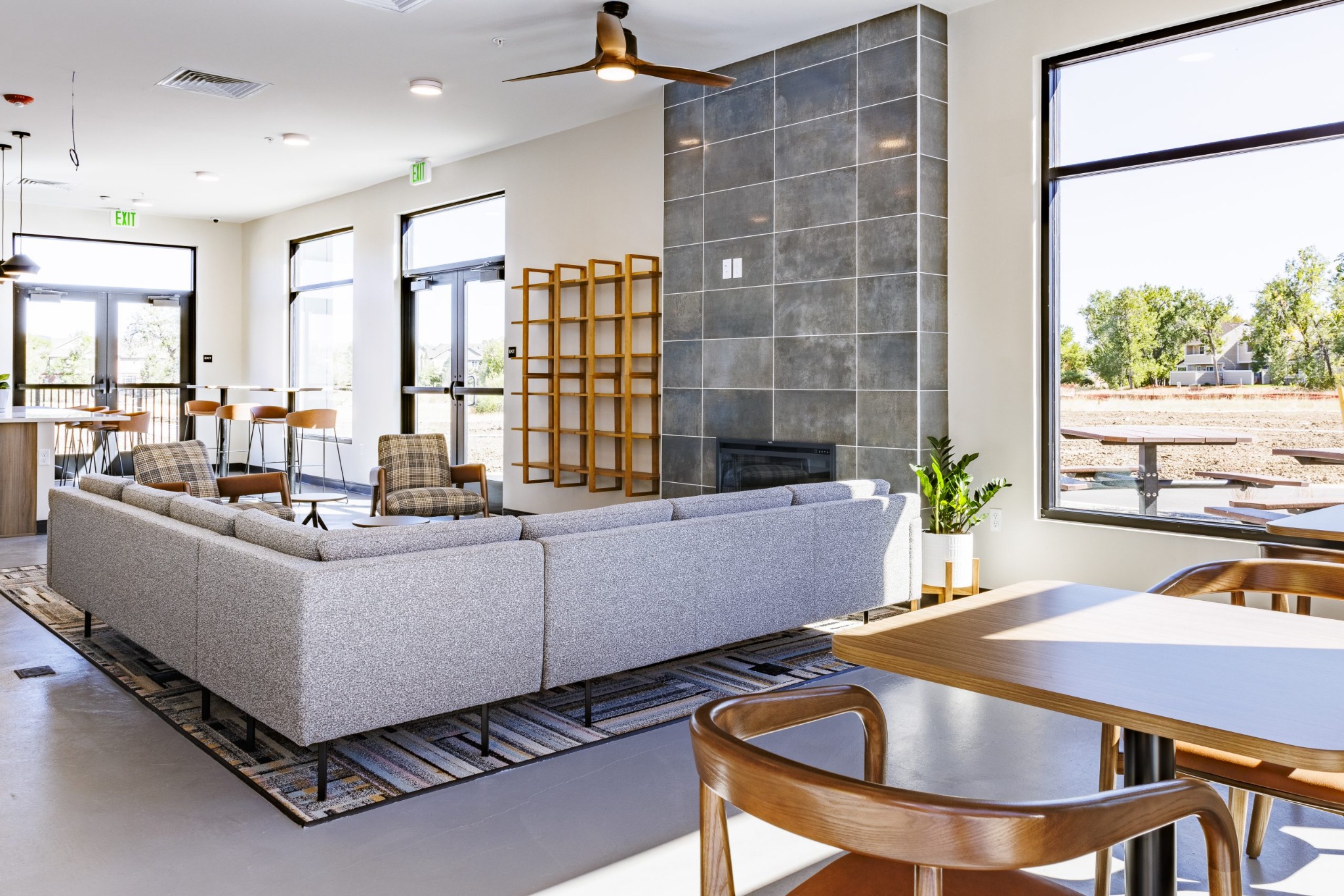 Bright clubhouse lounge with fireplace and generous windows