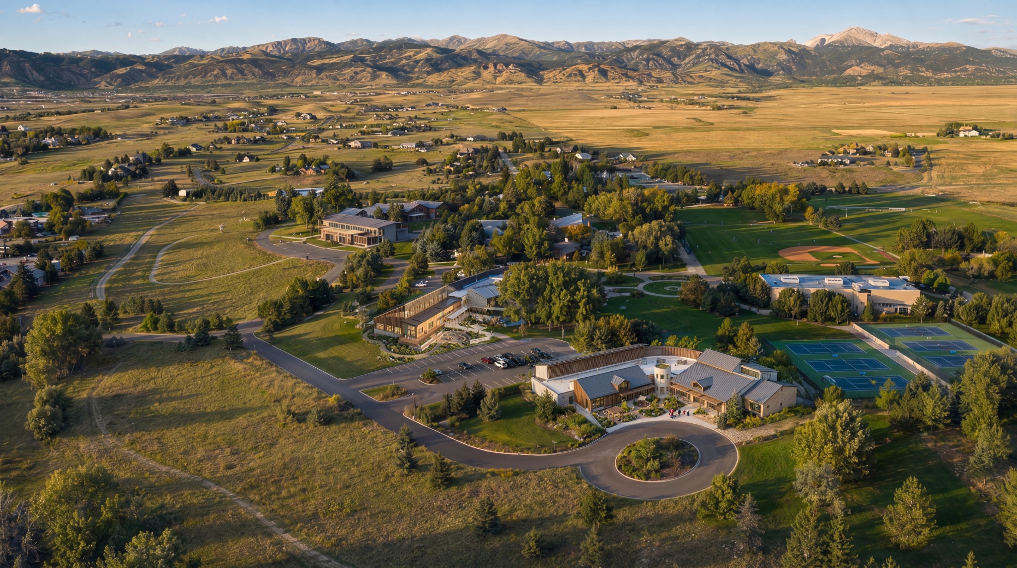 Campus planning rendering in a landscaped setting with mountain views
